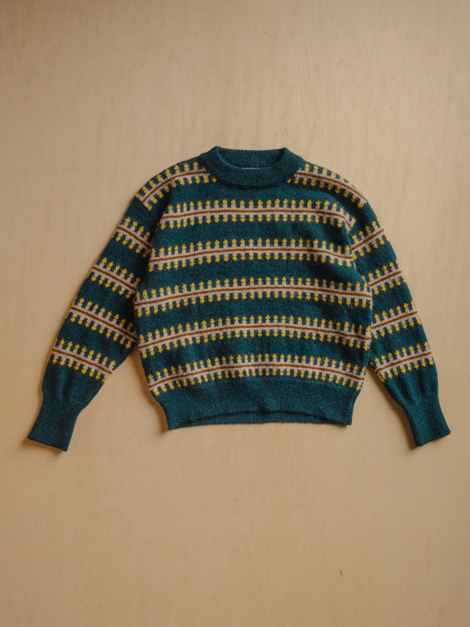 The Endery Vera Fairisle Sweater in Juniper — a deep teal fair isle knit banded with mustard, cream and warm brown, in alpaca