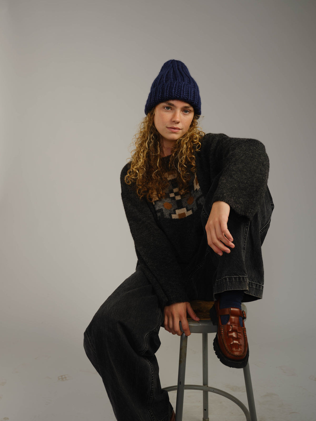 The Workwear hand-knit merino wool beanie in Blueprint, worn
