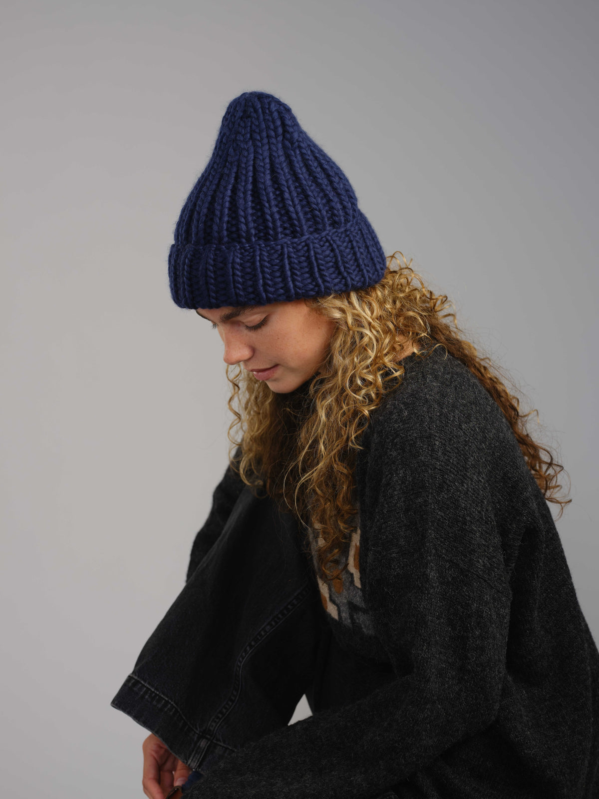 The Workwear merino beanie in Blueprint, worn — alternate view