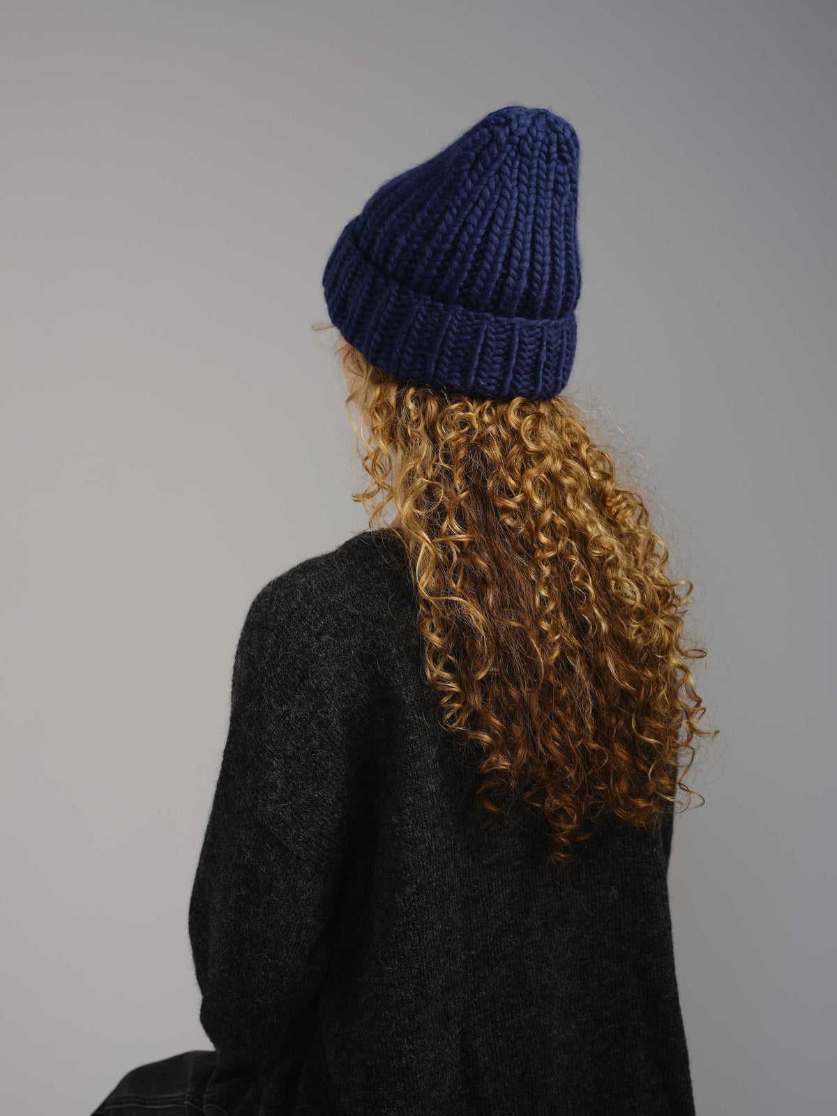 The Workwear merino beanie in Blueprint, worn — alternate view