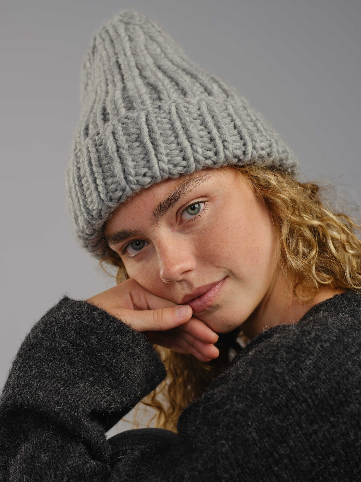 The Workwear hand-knit merino wool beanie in Pewter, worn