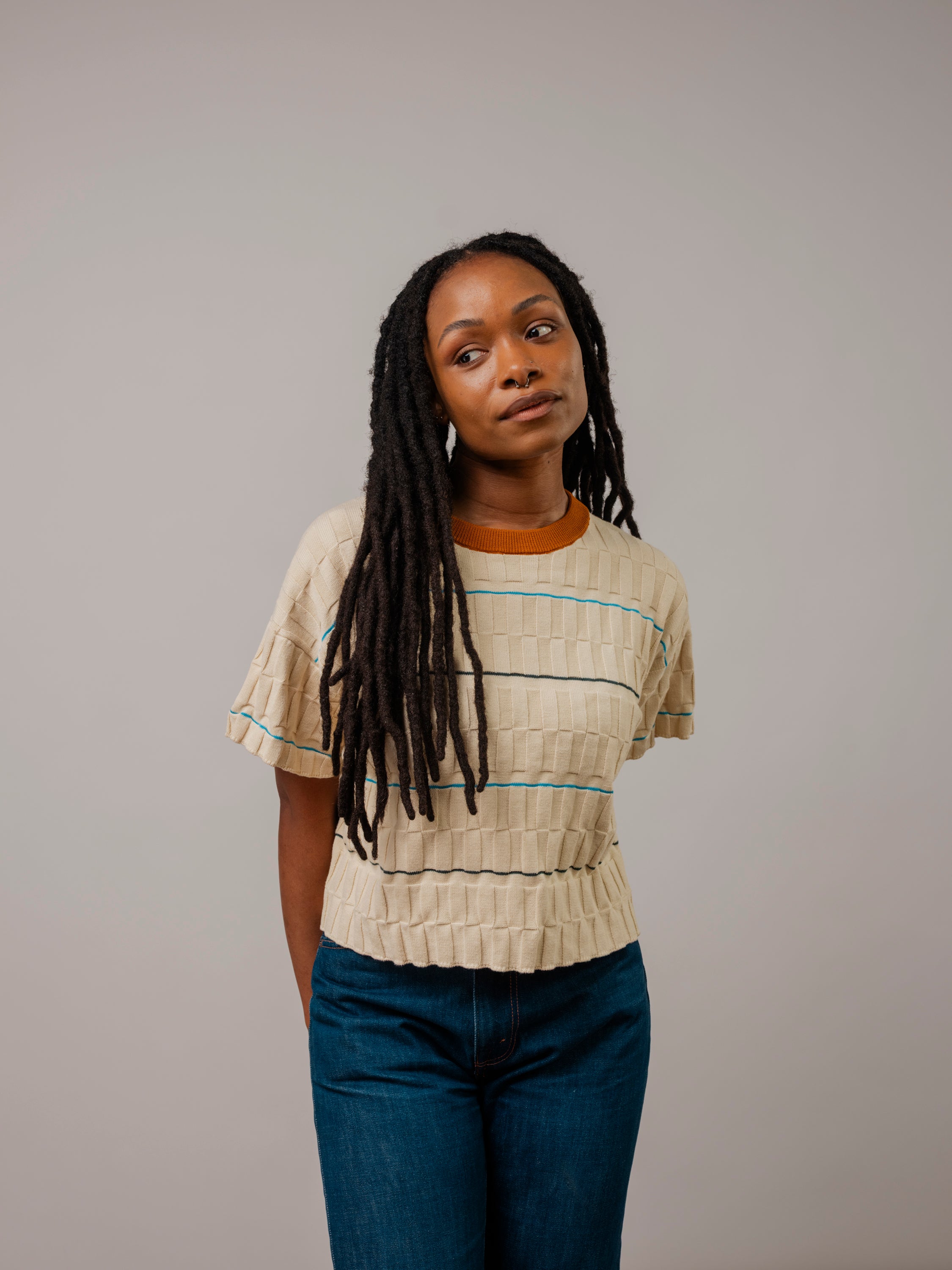 Model wearing The Wiggle Stripe Knit Grid Tee, a boxy, draped fit made from rescued cotton and viscose.