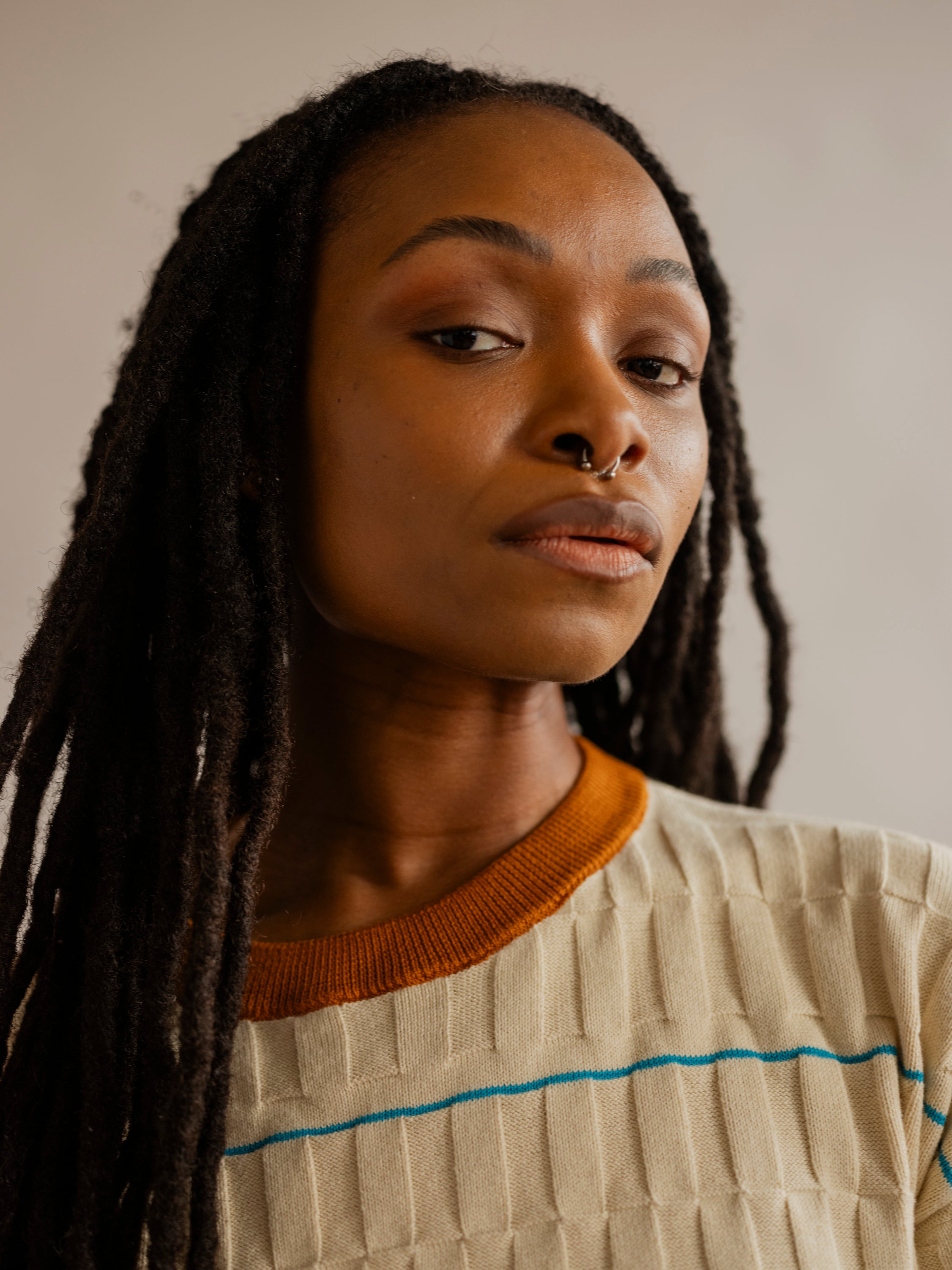 Close-up detail of the wiggle stripe grid tee, a cotton short sleeve sweater tee.