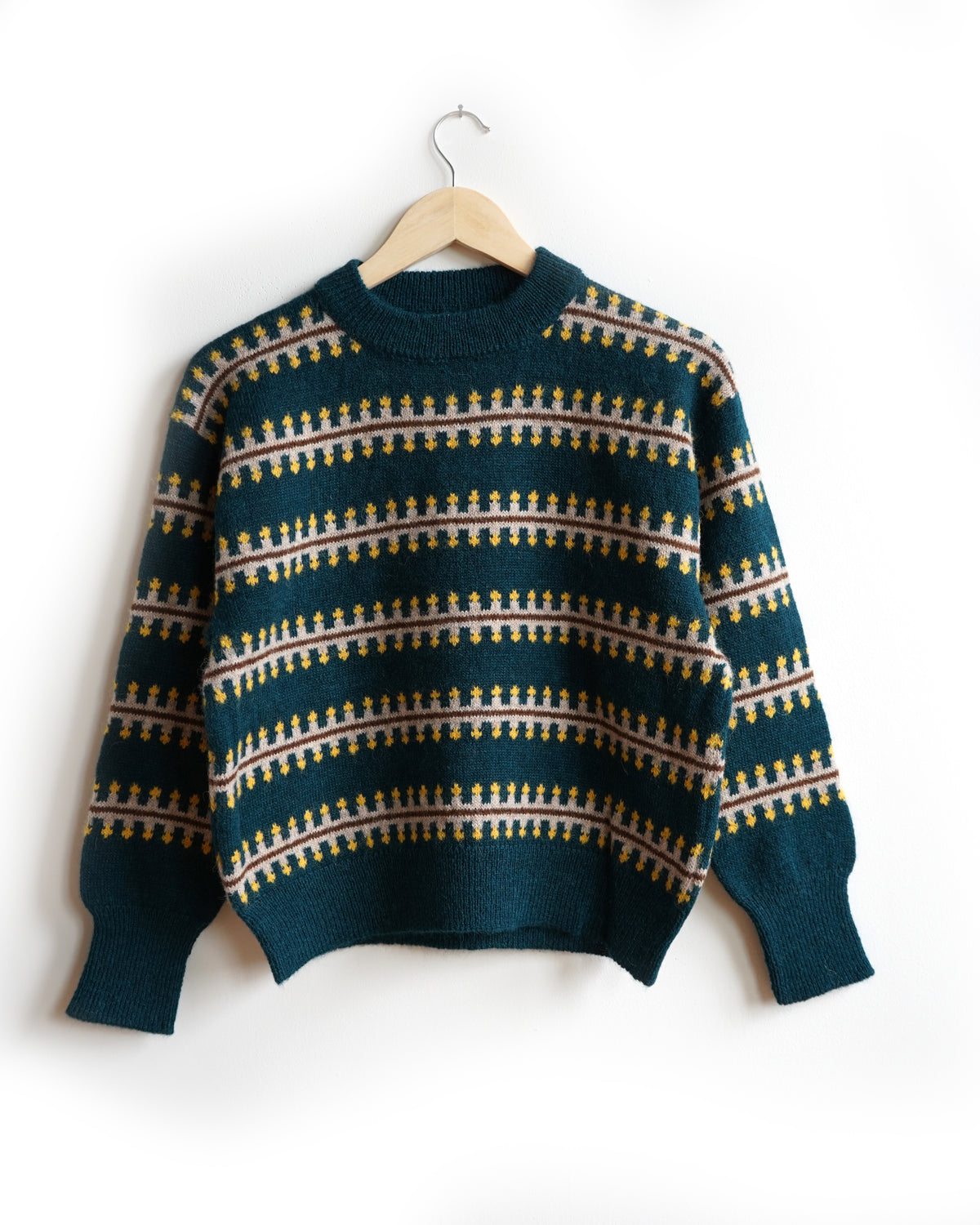The Endery Vera Fairisle Sweater in Juniper — a deep teal fair isle knit banded with mustard, cream and warm brown, in alpaca