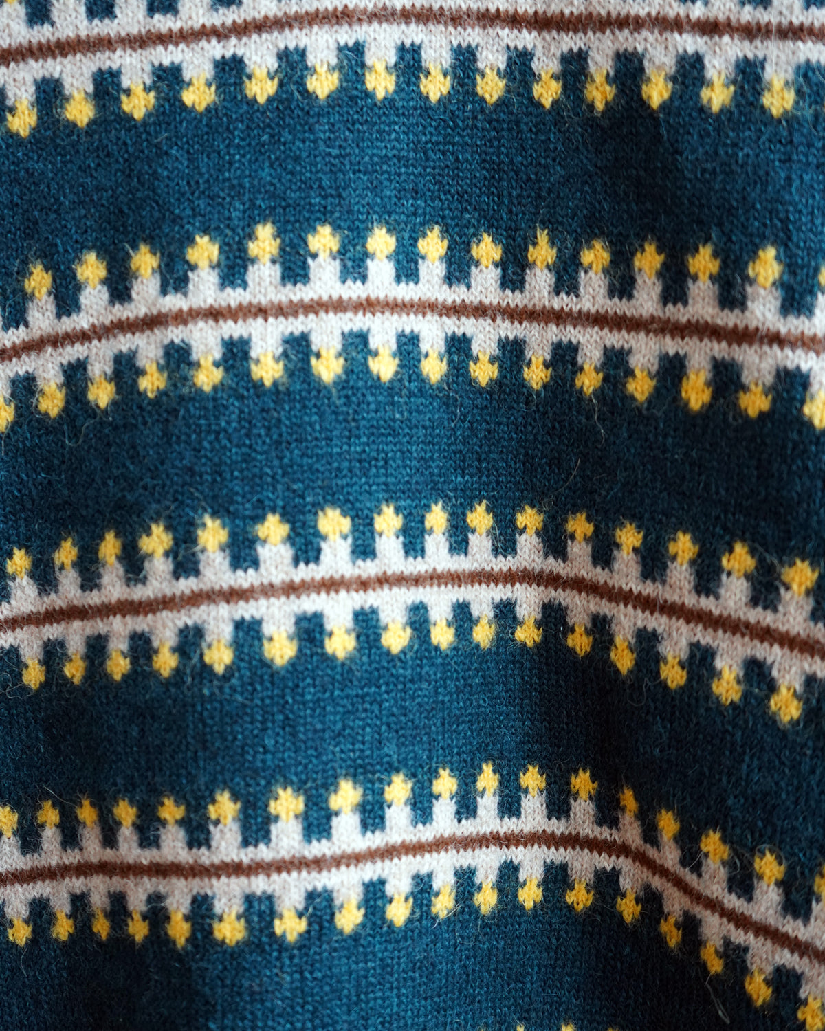 The Endery Vera Fairisle Sweater in Juniper — a deep teal fair isle knit banded with mustard, cream and warm brown, in alpaca