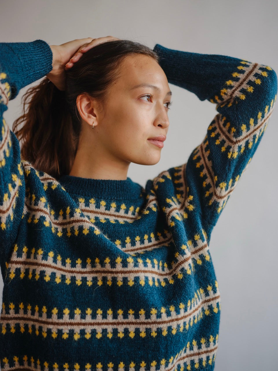 The Endery Vera Fairisle Sweater in Juniper — a deep teal fair isle knit banded with mustard, cream and warm brown, in alpaca