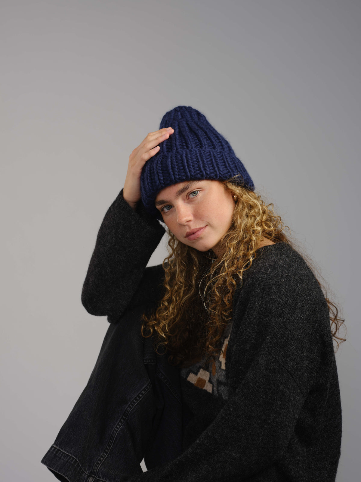 The Workwear merino beanie in Blueprint, worn — alternate view