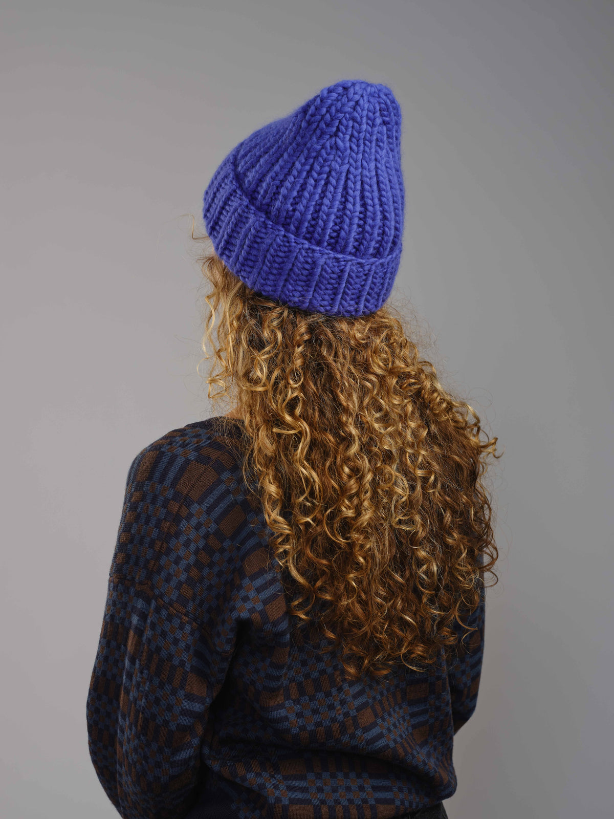The Workwear merino beanie in Lapis, worn — alternate view